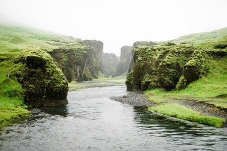 River with green cliffs banks