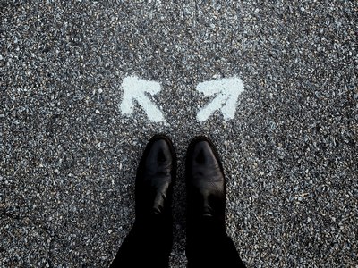 Shoes in front of 2 arrows in which a decision needs to be made