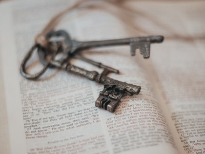 Old fashioned skeleton keys on a open Bible