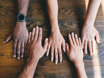 Alternating hands of diverse people