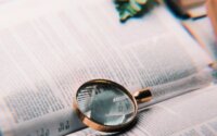 Bible with magnifying glass