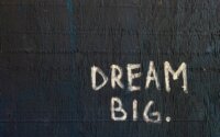 A hand painted sign that says Dream Big.