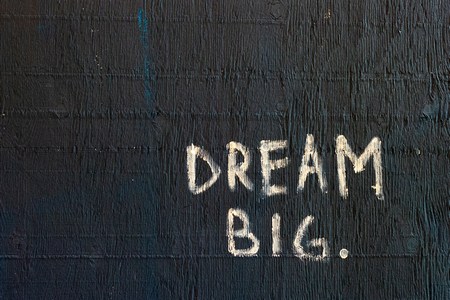 A hand painted sign that says Dream Big.